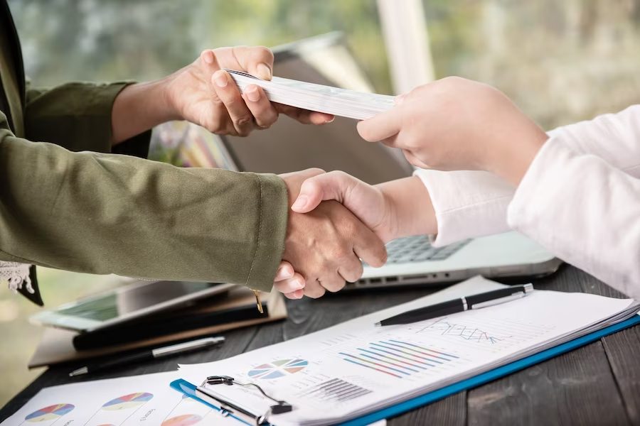 business people shaking hands finishing small business loan